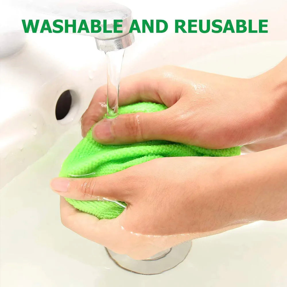 Green microfibre pad being rinsed under a tap - washable and reusable
